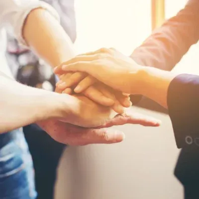 Image of people holding hands together in celebration